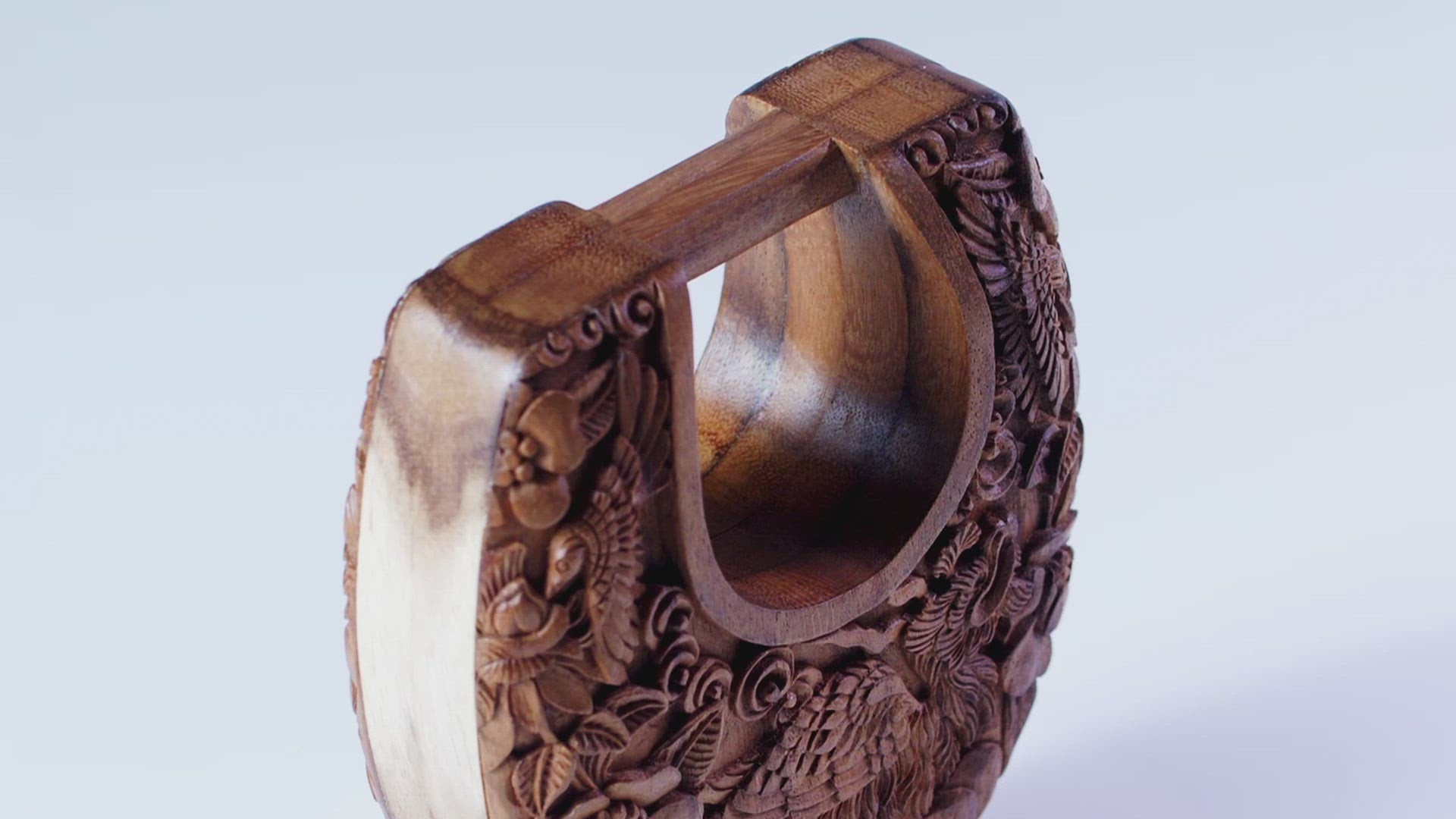 Video of mini wood carved ushape bag and of large wood shape bag. The most luxurious bags ever to be made, hand-carved from solid wood, these bags are the definition of luxury and the ultimate investment handbags. Timeless elegant perfection in the form of a purse. The Simurgh, the mythical bird of God, is benevolent, healing, and mystical. She is carved here in her kingdom resplendent with the mythical worlds of flowers, clouds, hummingbird, and quail. Simurgh's Kingdom Large Ushape Bag - Blumera