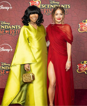 Brandy, with Rita Ora, carries Octagon Wood Chrome Clutch to Disney's Descendent Rise of the Red Premiere